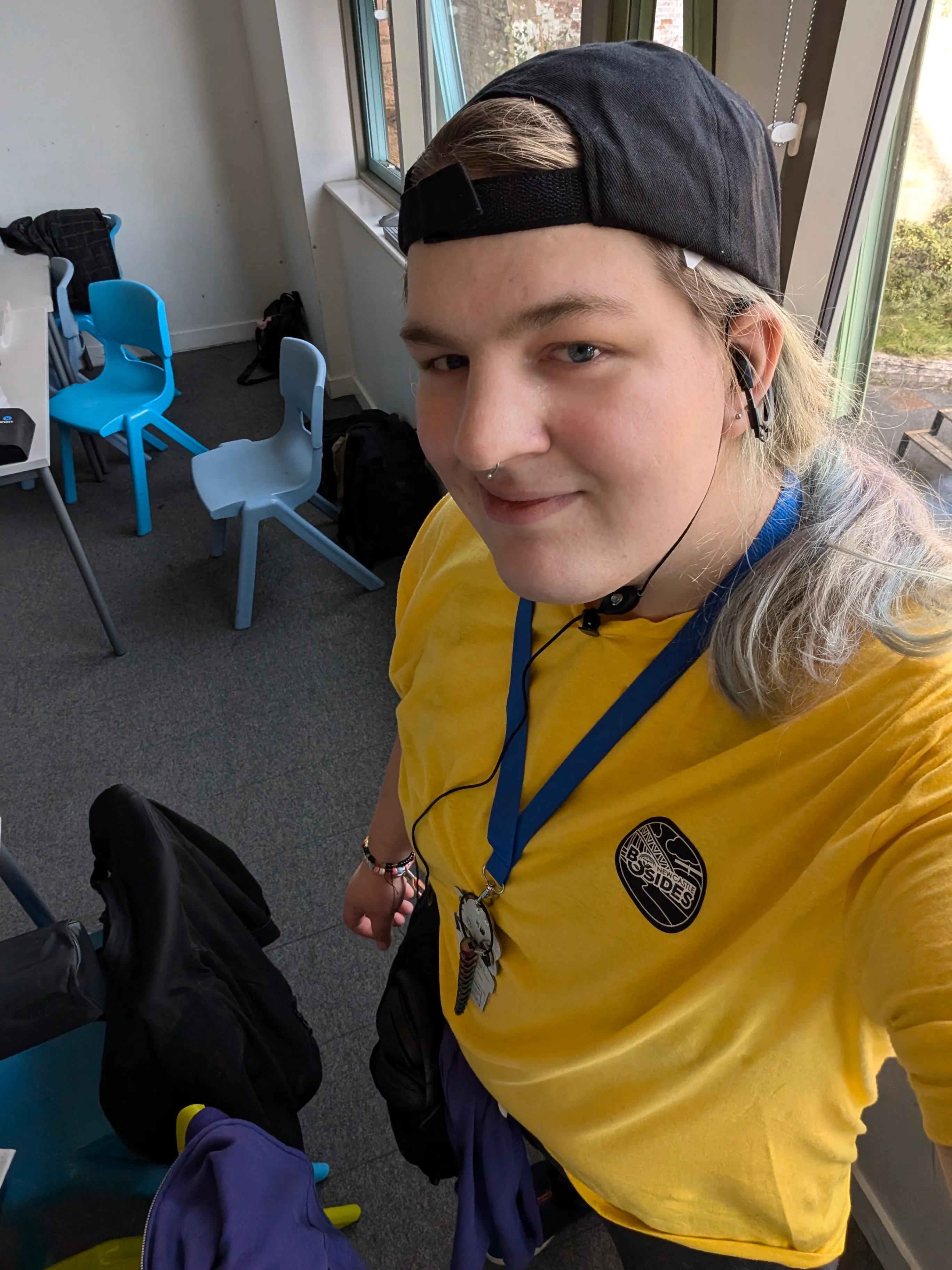 Picture of maya, it is wearing a yellow t-shirt and a ball cap