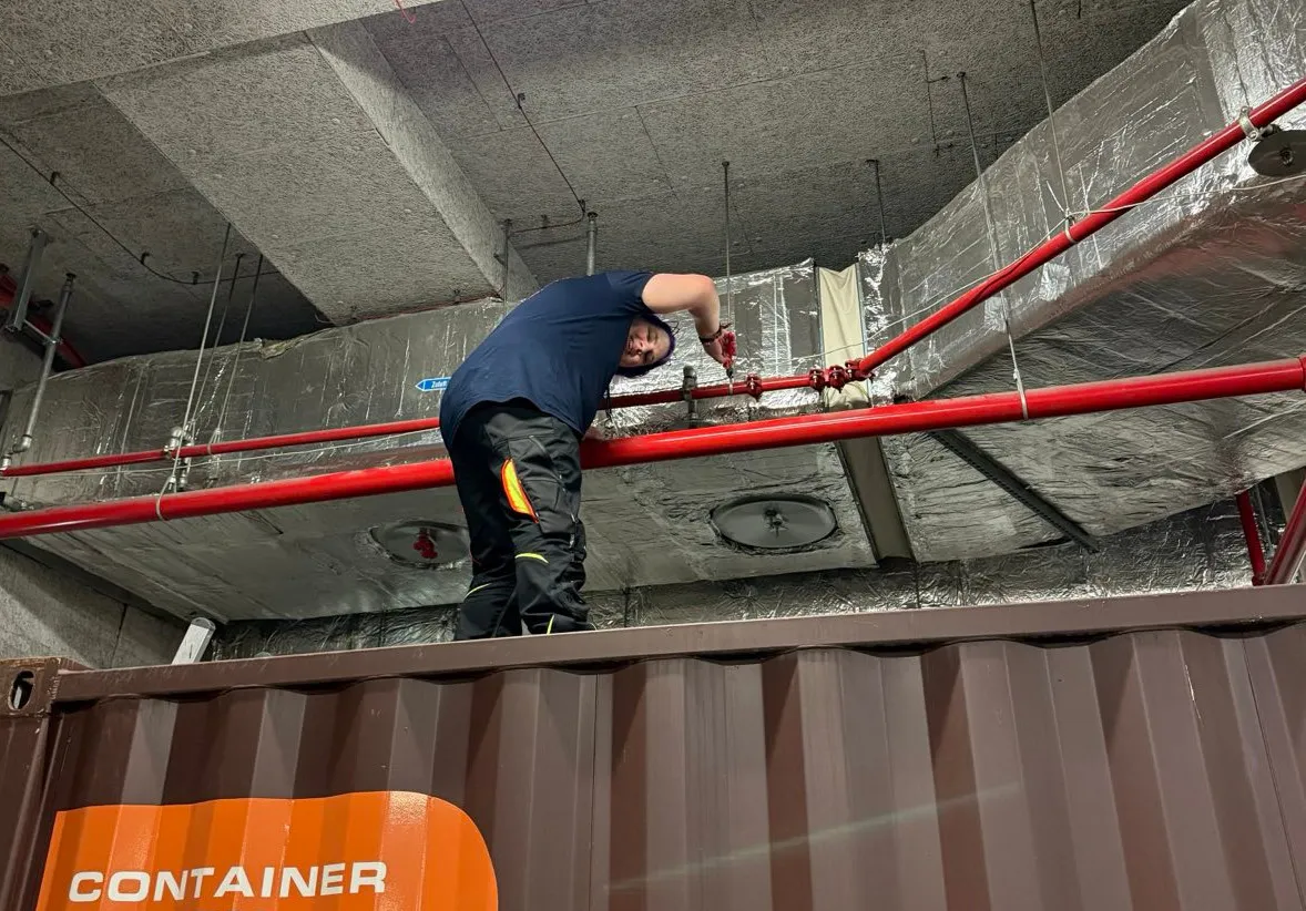 picture of maya standing on top of a shipping container