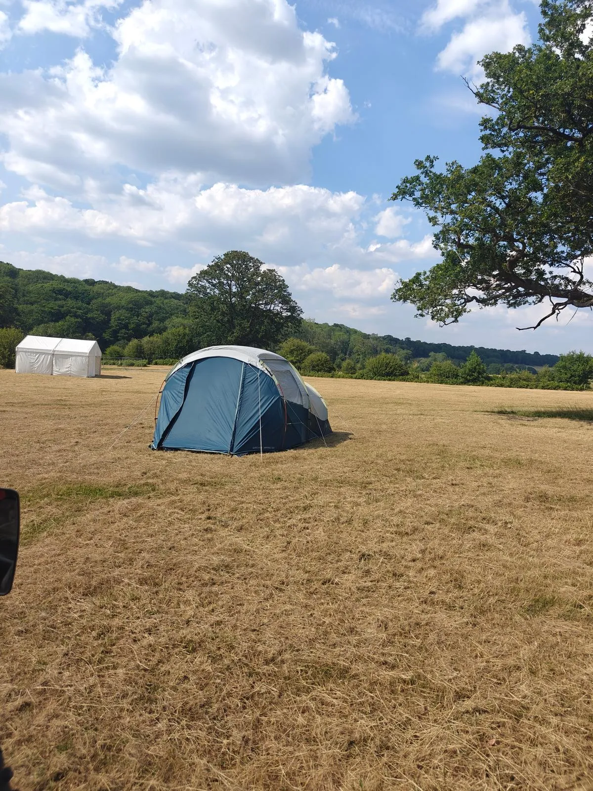picture of a single tent pitched in a very dry field