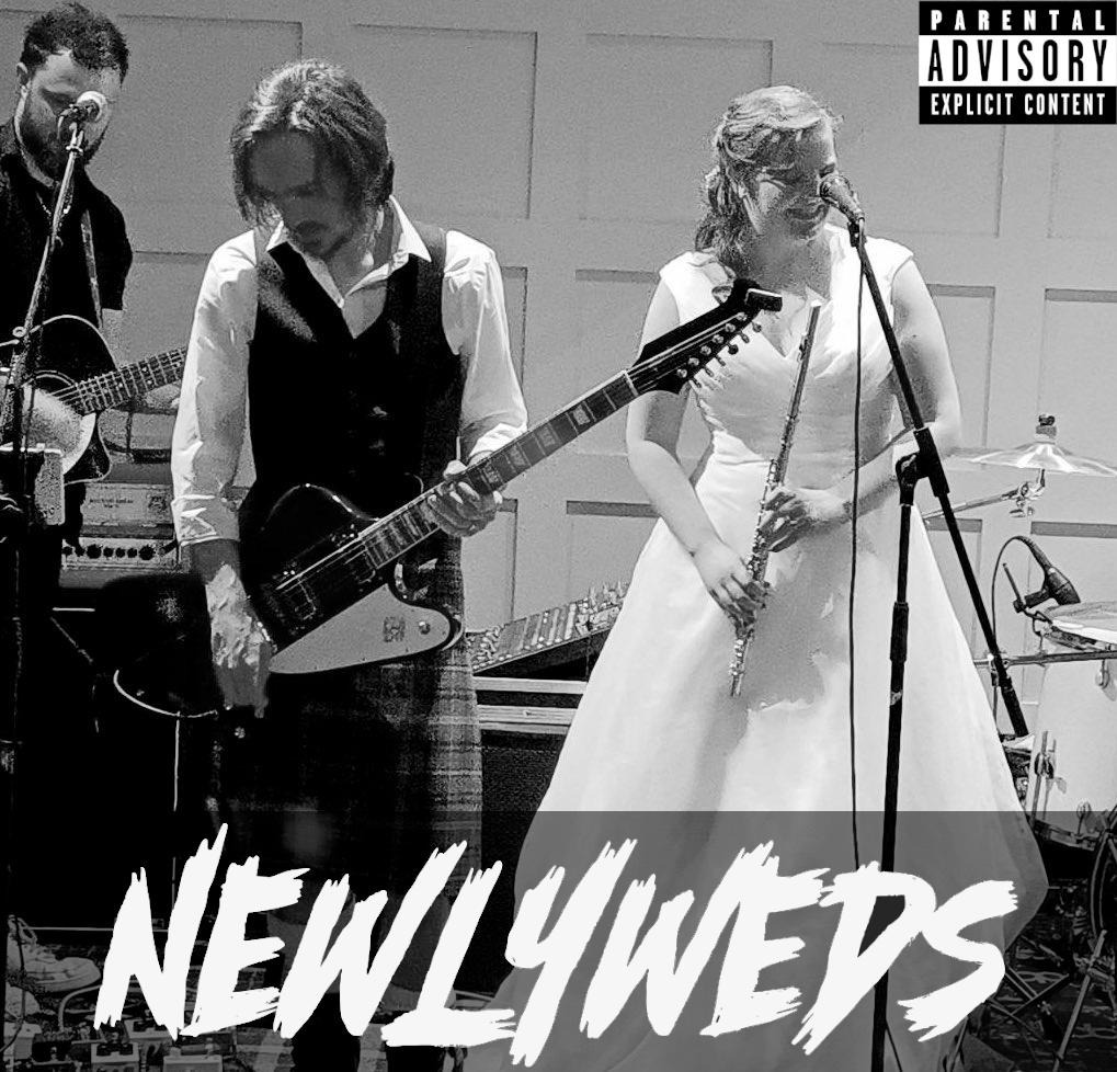 A picture of the wedding, converted to grayscale, with a tagline "Newlyweds" and a Parental Advisory notice