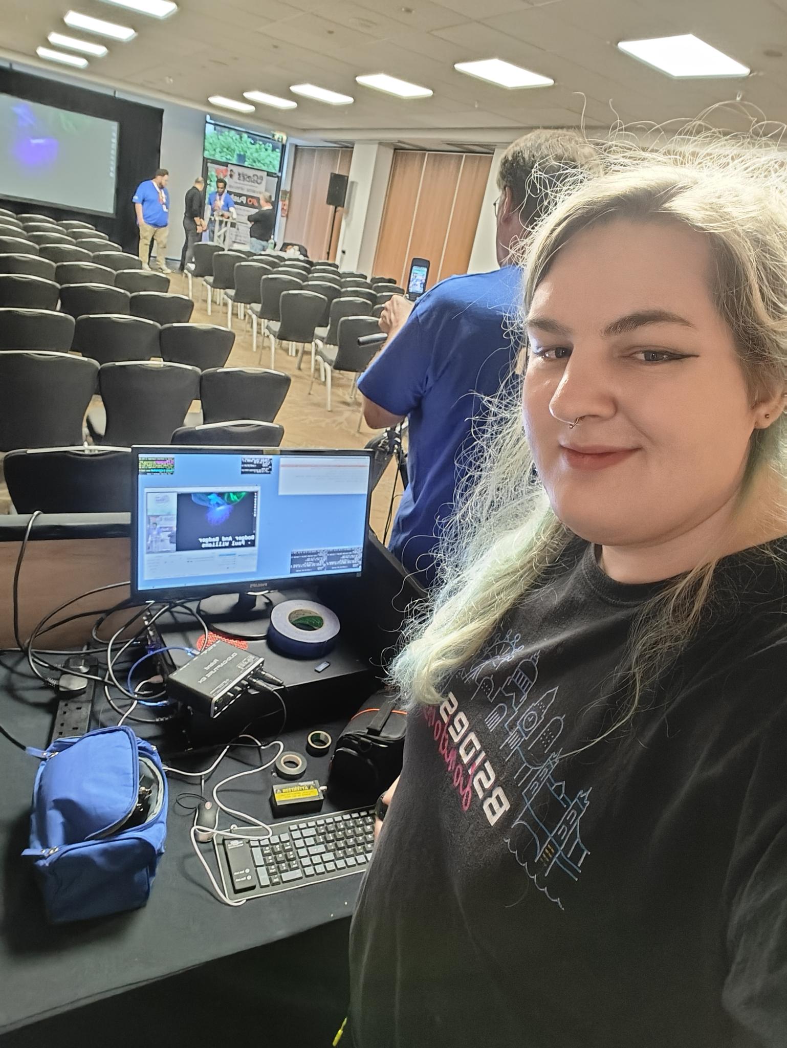 selfie of maya, Cooper can be seen operating the A/V desk laptop