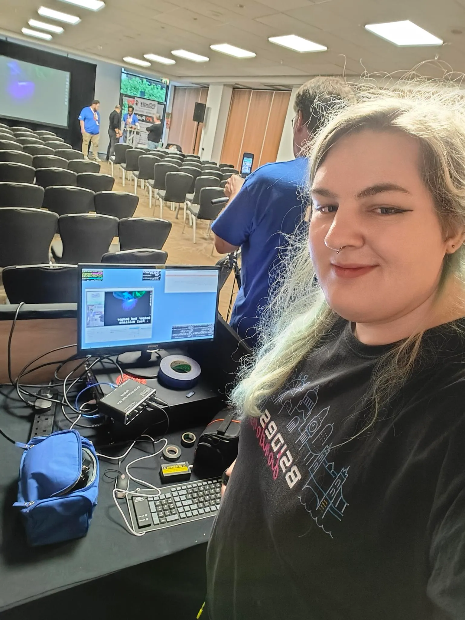 selfie of maya, Cooper can be seen operating the A/V desk laptop