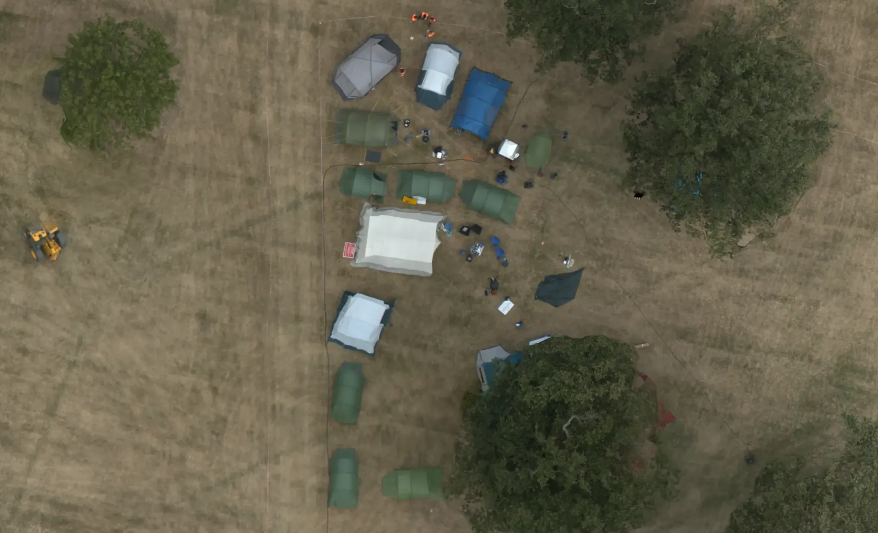 aerial picture of glastonledburyshire-on-severn's footprint in the field. one can see already 16 or so tents.